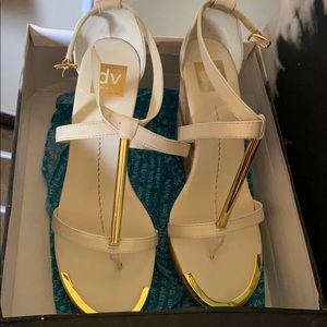 Dolce Vita gold, white strapped wedge sandals.